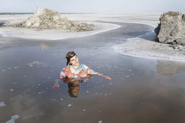 Women swim in a shallow pond that is a remnant of Lake Urmia. They walk almost two miles from the former beach to the pond several times each summer to bathe in the natural salt water. 2014